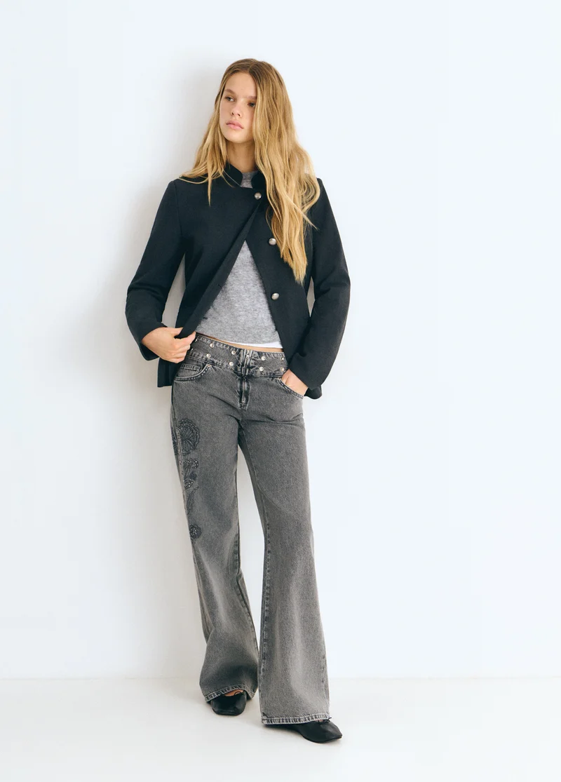 Jeans with a studded, embroidered waistband